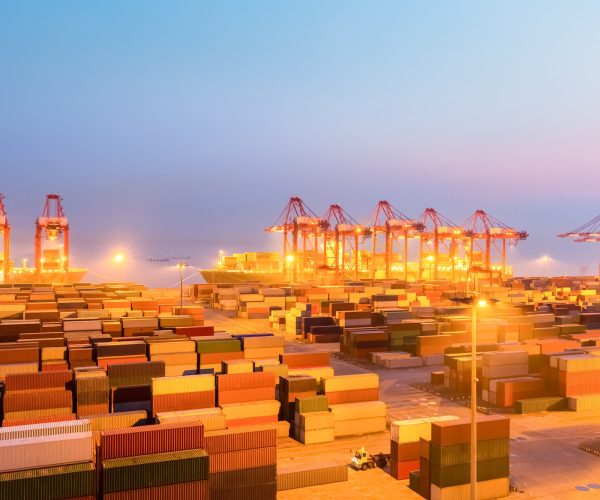 container wharf in nightfall, international import and export trade background