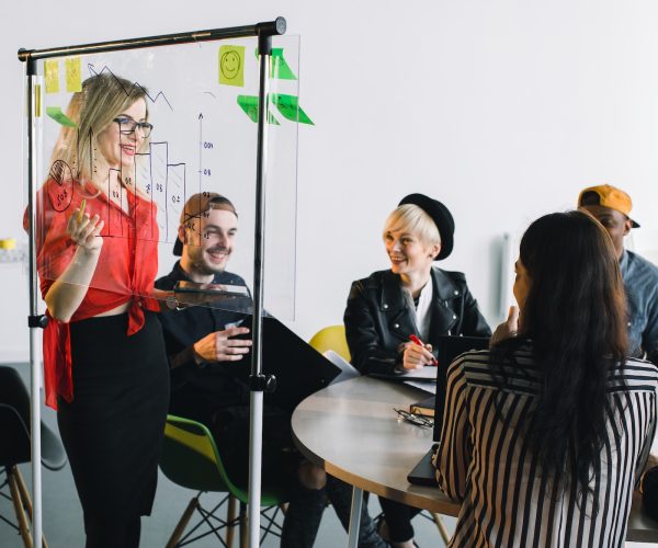 Portrait of young female team leader of talented freelances organizing work of members motivates and